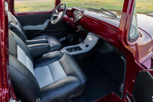 The custom console showing the reupholstery work and clean design of the panel.