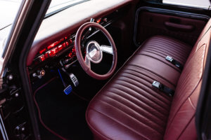ARJONAS UPHOLSTERY WRAPPED THE FACTORY BENCH IN KING RANCH GENUINE LEATHER, AND EVEN WENT AS FAR AS WRAPPING THE DASH AND RACELINE STEERING WHEEL IN THE SAME HIDE.
