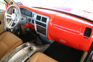 Interior showing the ultra orange and silver dashboard of the custom 1997 Toyota Tacoma