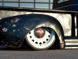 Mobsteel artillery wheels with cream-colored finish and hubcaps.