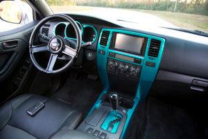 Simple and tasteful interior with Katzkin leather, a suede headliner and teal accents on the trim.