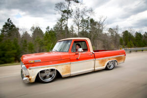 Lindsay Escoyne custom 1971 Ford F-100 driving down the street.