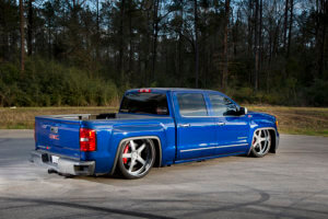 Custom blue 2014 GMC Sierra rear quarter view