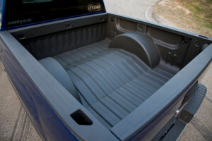 2014 GMC Sierra truck bed modified to accommodate the larger wheels.