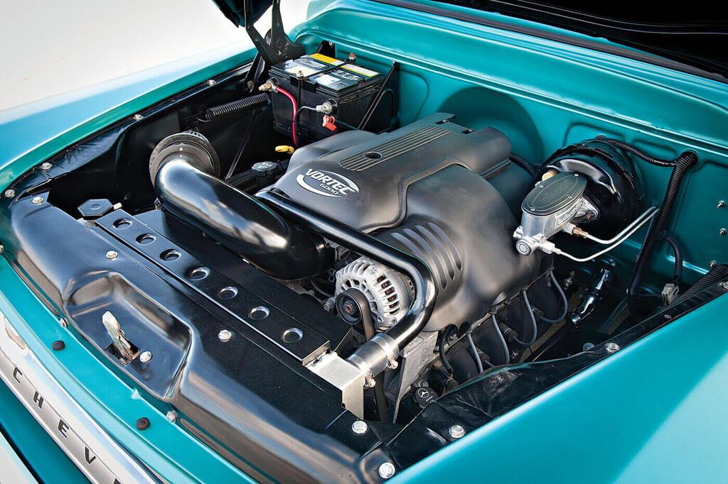 The engine compartment isn’t covered in shiny accessories; it was kept clean to pull off the illusion that it originally came with this modern LQ9 engine.