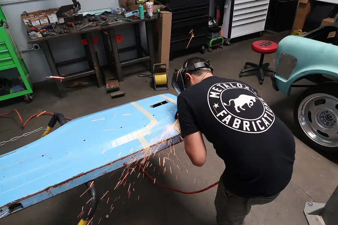 Using a die grinder, Kyle cuts the outer skin on the bedsides
