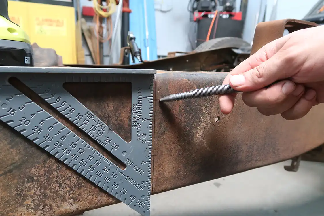 The new holes for the cab mounts are then measured out 12 inches farther back