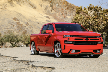 Red lowrider truck on the street in the wilderness