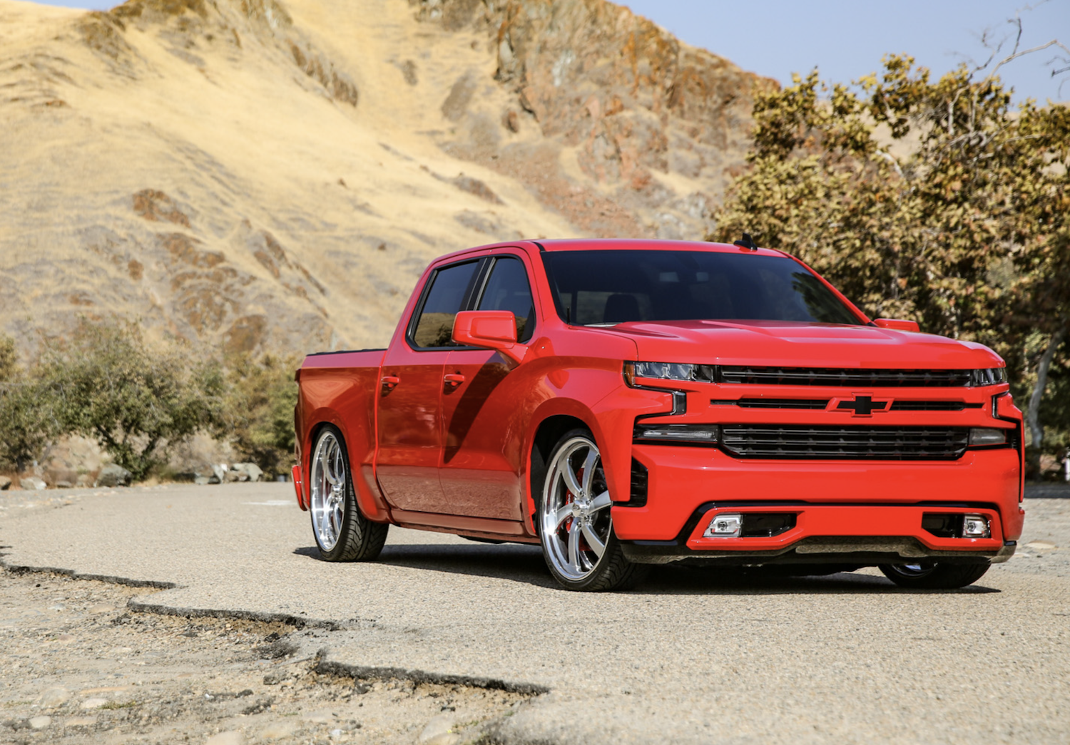 Red lowrider truck on the street in the wilderness