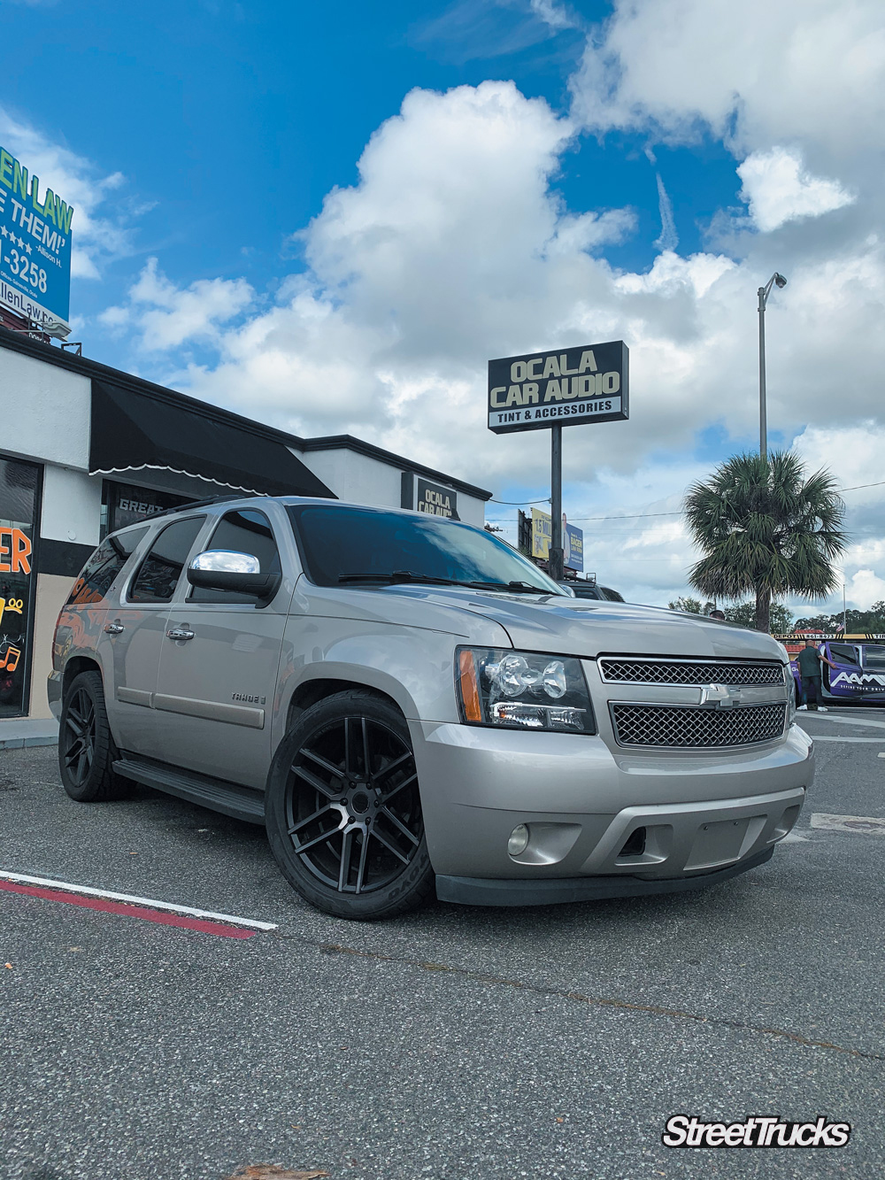 Tan Chevy Tahoe lowered with black wheels